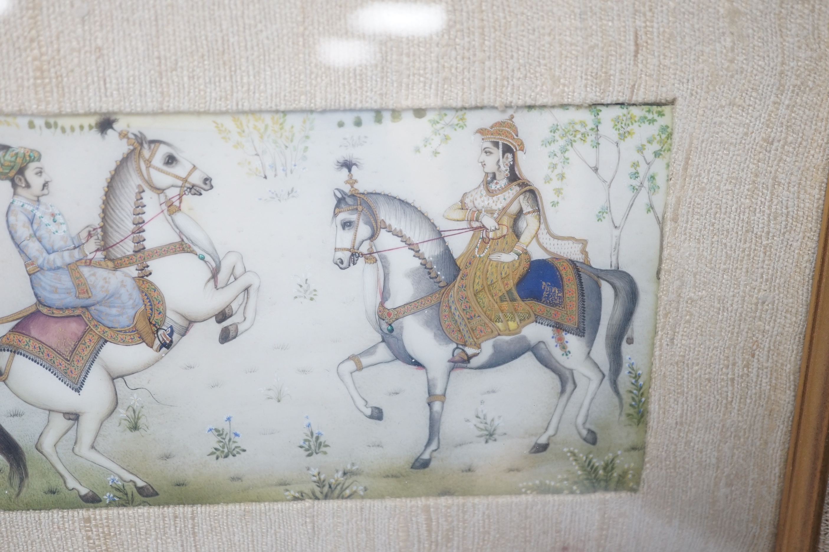 Indian Mughal style miniature on ivorine, 20th century depicting Shah Jehan - Mumtaz Ali on horseback, glazed frame, 20cm wide x 10cm high